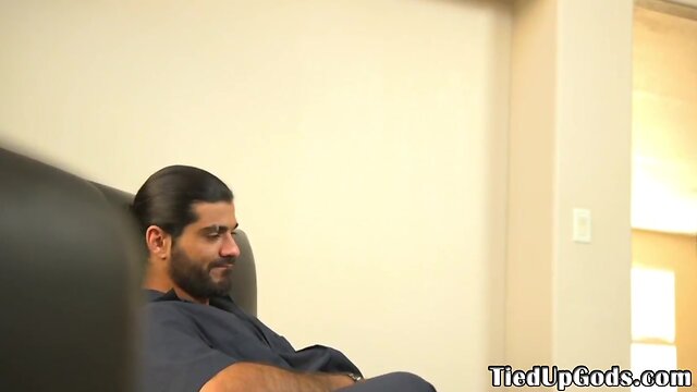 Restrained bdsm hunk blowing doms penis